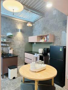 a kitchen with a table with glasses on it at DORI HOUSE NTL in Ho Chi Minh City