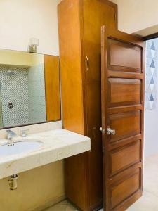 a bathroom with a sink and a mirror at Ko'ox 52 in Mérida