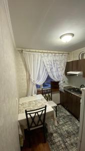 a kitchen with a table and chairs in a room at 2х комнатная квартира на Толе би in Taraz