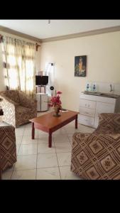 a living room with a coffee table and a couch at THE DESERT ROSE HOTEL VOI in Voi