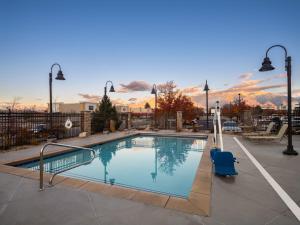 a large swimming pool with a blue chair next to it at Staybridge Suites Midvale, an IHG Hotel in Midvale