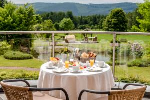 a table with food and drinks on a balcony at Landhotel Heimathenhof in Heimbuchenthal