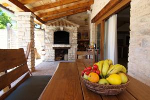 BarbanにあるVilla Milica - Istrian ecohouseの木製テーブルと暖炉の上にフルーツバスケット