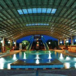 a large swimming pool with a water slide at Arzel Resort in Mangatarem