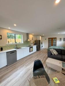 a large kitchen and living room with a couch at Heart of Witchcliffe in Margaret River Town