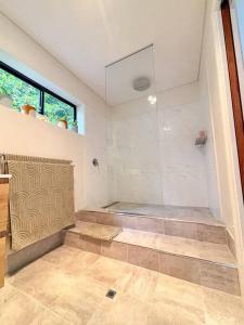 a bathroom with a shower with a glass door at Heart of Witchcliffe in Margaret River Town