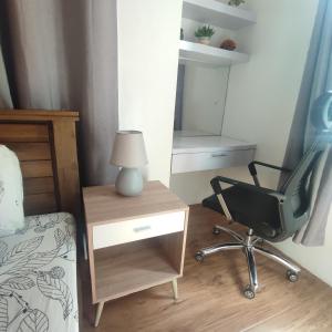 a bedroom with a desk and a chair and a mirror at Luxury spacious 2BR in Salcedo Village in Manila