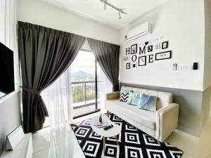 a living room with a couch and a window at Decozy 8.0 IpohTownCondo (10pax) in Ipoh