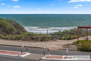 a view of the ocean from the side of a road at Esplanade Gateway in Port Noarlunga South