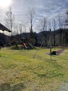 a park with a playground with a slide at Wohnen am Almufer - Ferienwohnung Straßmair in Grünau im Almtal