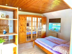 1 dormitorio con cama y techo de madera en Ferienhaus Delia, en Dannewerk
