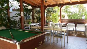 a pool table in a restaurant with tables and chairs at Panklitos Tourist Apartments in Paphos