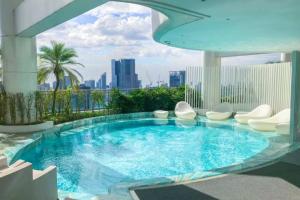 a swimming pool on the roof of a building at Queen Suite with City View at Acqua Private Residences in Manila