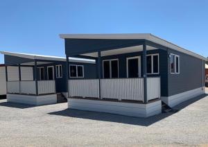 a blue and white building with a lot at Seaspray Beach Holiday Park in Dongara