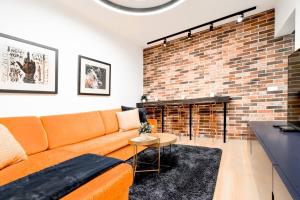 a living room with a couch and a brick wall at 2bdr Luxury Fully Equipped Prime Location in Sofia