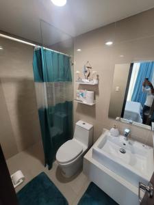 a bathroom with a toilet and a sink and a shower at Boracay Newcoast top floor view in Boracay +11 photos