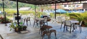 a group of tables and chairs in a patio at Rovers Inn Guest House in Tanah Rata