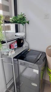 a desk with a computer and a plant on top at The Healing Homestay Putrajaya in Putrajaya