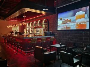 a bar in a restaurant with a large screen at Fun Stay Inn Ximen in Taipei