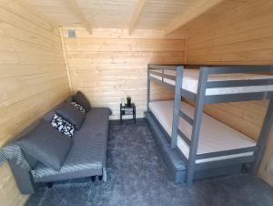 a room with two bunk beds and a couch at Kanarbiku camping in Türi
