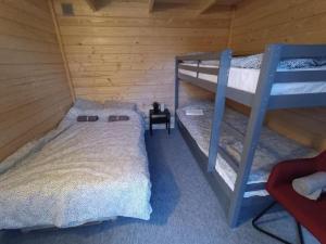 a bedroom with two bunk beds in a cabin at Kanarbiku camping in Türi