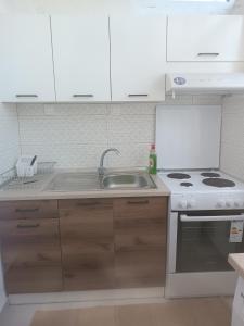 a kitchen with a sink and a stove at Kipseli 1 in Kozani