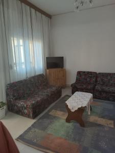 a living room with a couch and a coffee table at Kipseli 1 in Kozani