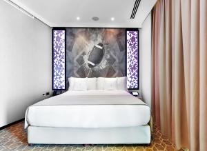Ένα ή περισσότερα κρεβάτια σε δωμάτιο στο The Torch Doha