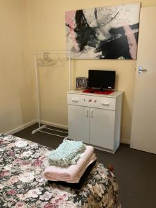 a bedroom with a bed and a desk with a laptop on it at Do Drop Inn 188 Clarke St east, CAREY PARK W A in Carey Park