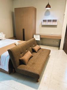 um sofá num quarto com uma cama em Apartment Nawasena em Sanur
