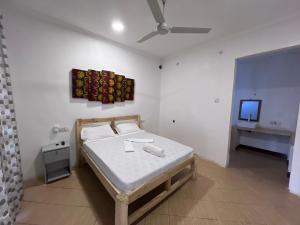 a bedroom with a bed and a tv in it at New Dindini Lodge in Kilindoni