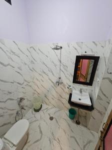 a bathroom with a toilet and a sink at Hotel Royal Haveli in Jaisalmer