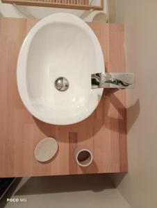 a bathroom with a white sink and a mirror at Artbnb in Lézat-sur-Lèze