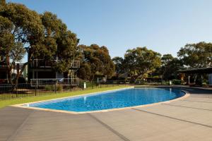 an empty swimming pool in a park with trees at Dunes Villa South Shores Normanville walk to beach in Normanville