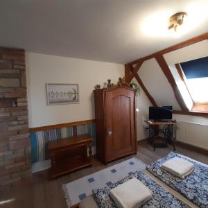 a living room with a wooden cabinet and a window at Hungária Vendégház in Eger +66 photos