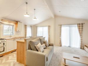 a living room with a couch and a kitchen at Roseberry Topping - Uk42937 in Great Broughton