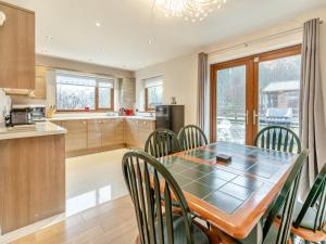 a kitchen and dining room with a table and chairs at Wernddu Fechan Bungalow - Uk42931 in Neath