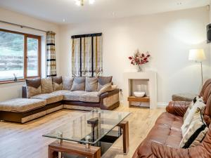 a living room with a couch and a table at Wernddu Fechan House - Uk42932 in Neath