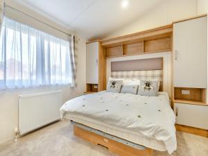 a bedroom with a large bed and a large window at Wainstones Rocks - Uk42938 in Great Broughton