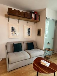 a living room with a couch and a table at Montmartre Bright & Quiet in Paris