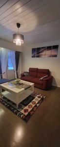 a living room with a couch and a table at 3 bedrooms, sauna and kitchen All house in Pori +30 photos