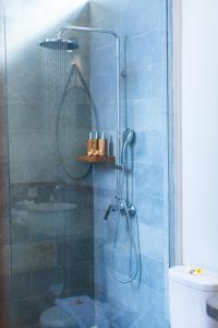 a shower with a glass door in a bathroom at Nalika Beach Resort & Restaurant - Adults Only in Umeanyar