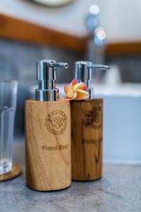 a couple of bottles of hair freseners sitting on a counter at Nalika Beach Resort & Restaurant - Adults Only in Umeanyar