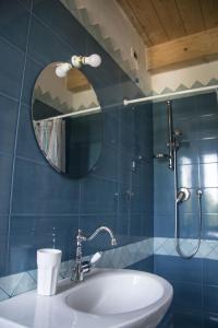 a bathroom with a sink and a mirror at Le Viole B&B in Mergo +29 photos
