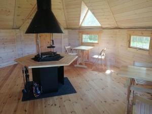 a room with a stove in a wooden cabin at Agroturystyka Dzikie Stawy-Mazury in Golubie Wężewskie