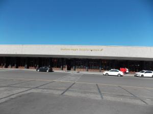 a large building with cars parked in front of it at Central House in Reggio di Calabria