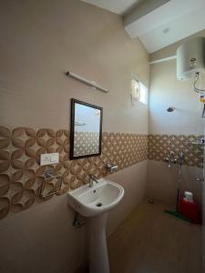 a bathroom with a sink and a mirror on the wall at House by the Hills in Dehradun