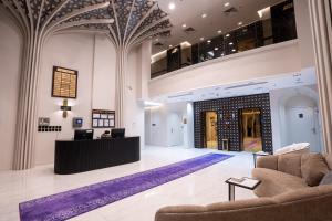 um átrio com dois sofás e uma recepção em فندق كنانة العزيزية من سما em Meca
