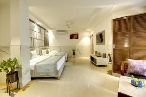 a bedroom with a bed and a television in it at Hotel Delhi 37 by Star Group NEAR DELHI AIRPORT in New Delhi