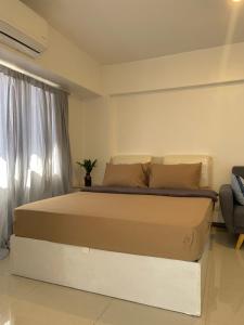 a bedroom with a large bed in a room at The Premier Suite in Pusok
